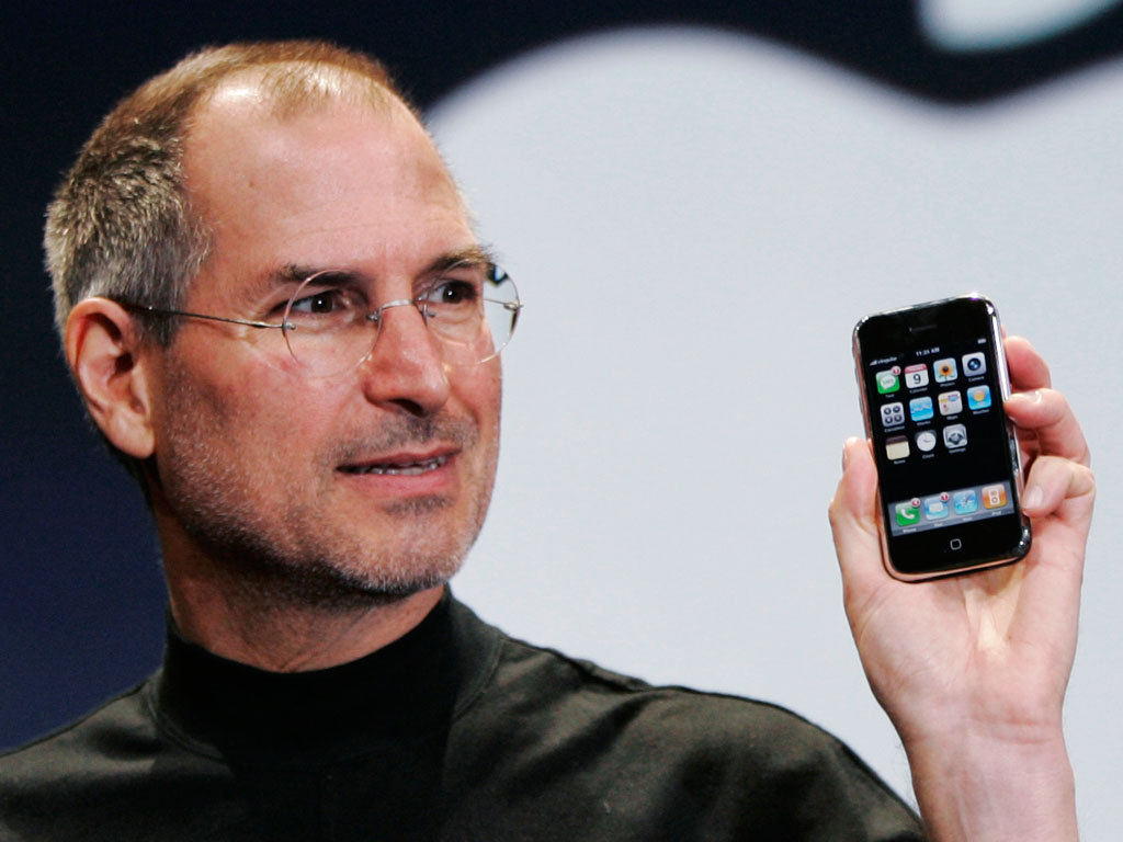 Apple CEO Steve Jobs Steve Jobs Holding an iPhone